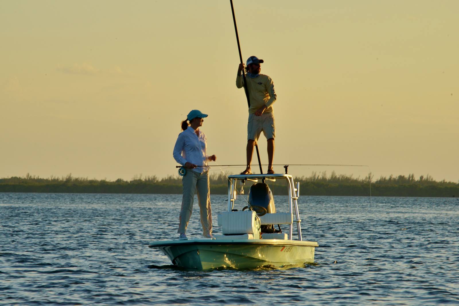 Poling the skiff at golden hour on Pine Island Sound